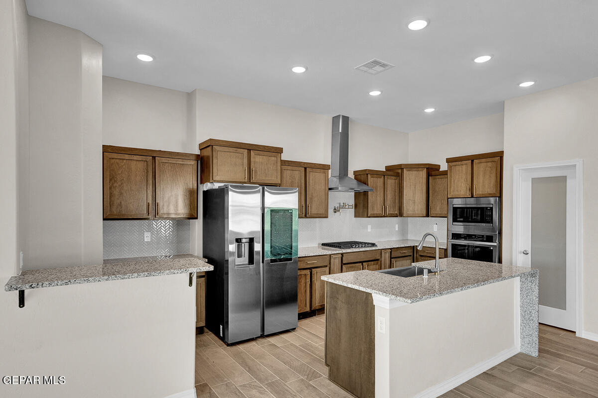 6935 Levee Circle El Paso, TX 79932 - Photo 10 of 32 a kitchen with stainless steel appliances granite countertop a refrigerator and a stove