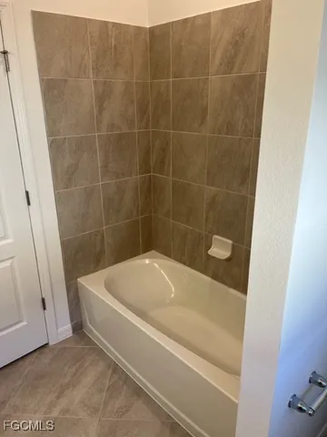 a white bath tub sitting in a bathroom