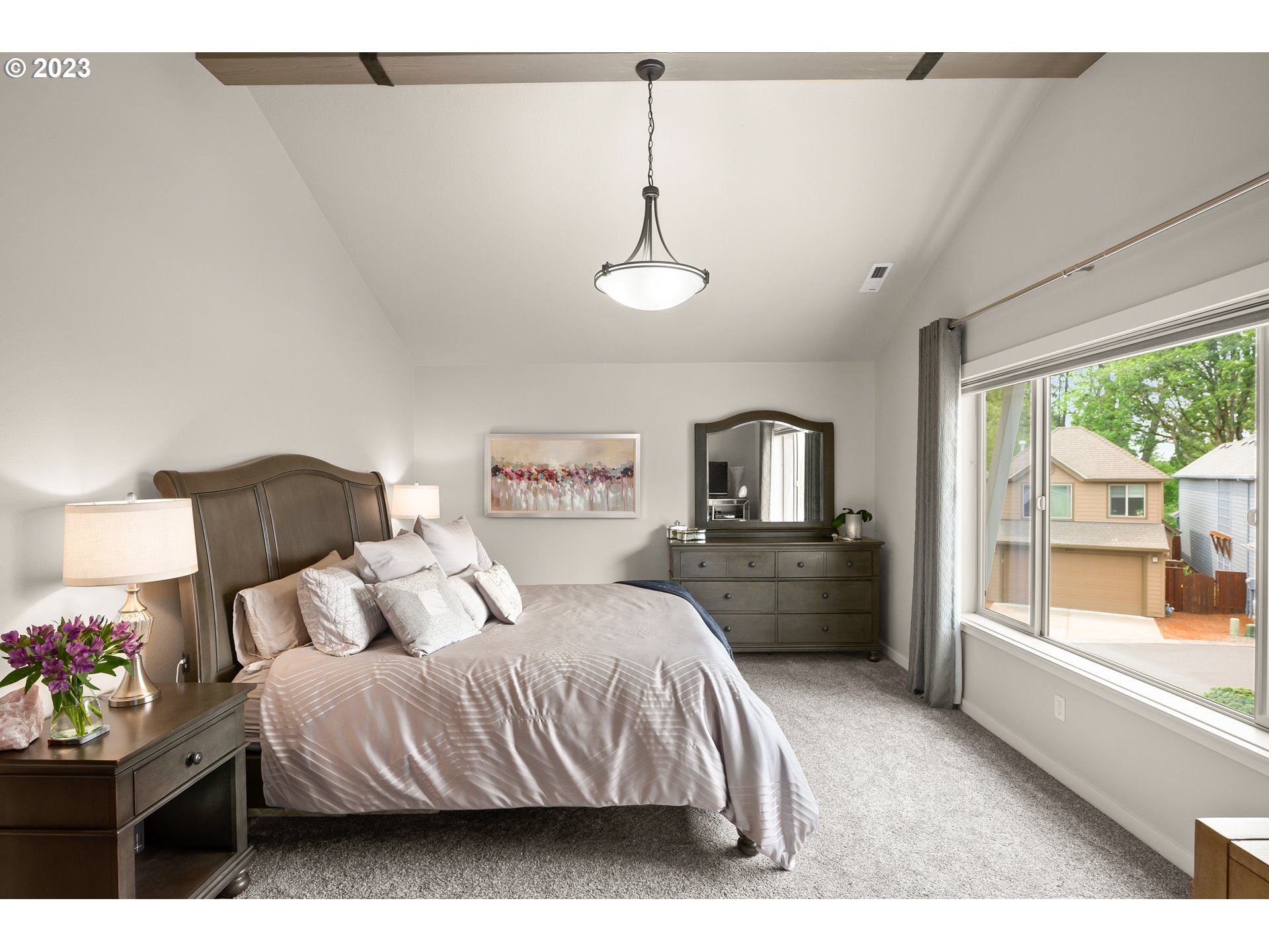 8964 Southwest Taylors Ferry Road Portland, OR 97223 - Photo 20 of 32 a bedroom with a large bed and a window