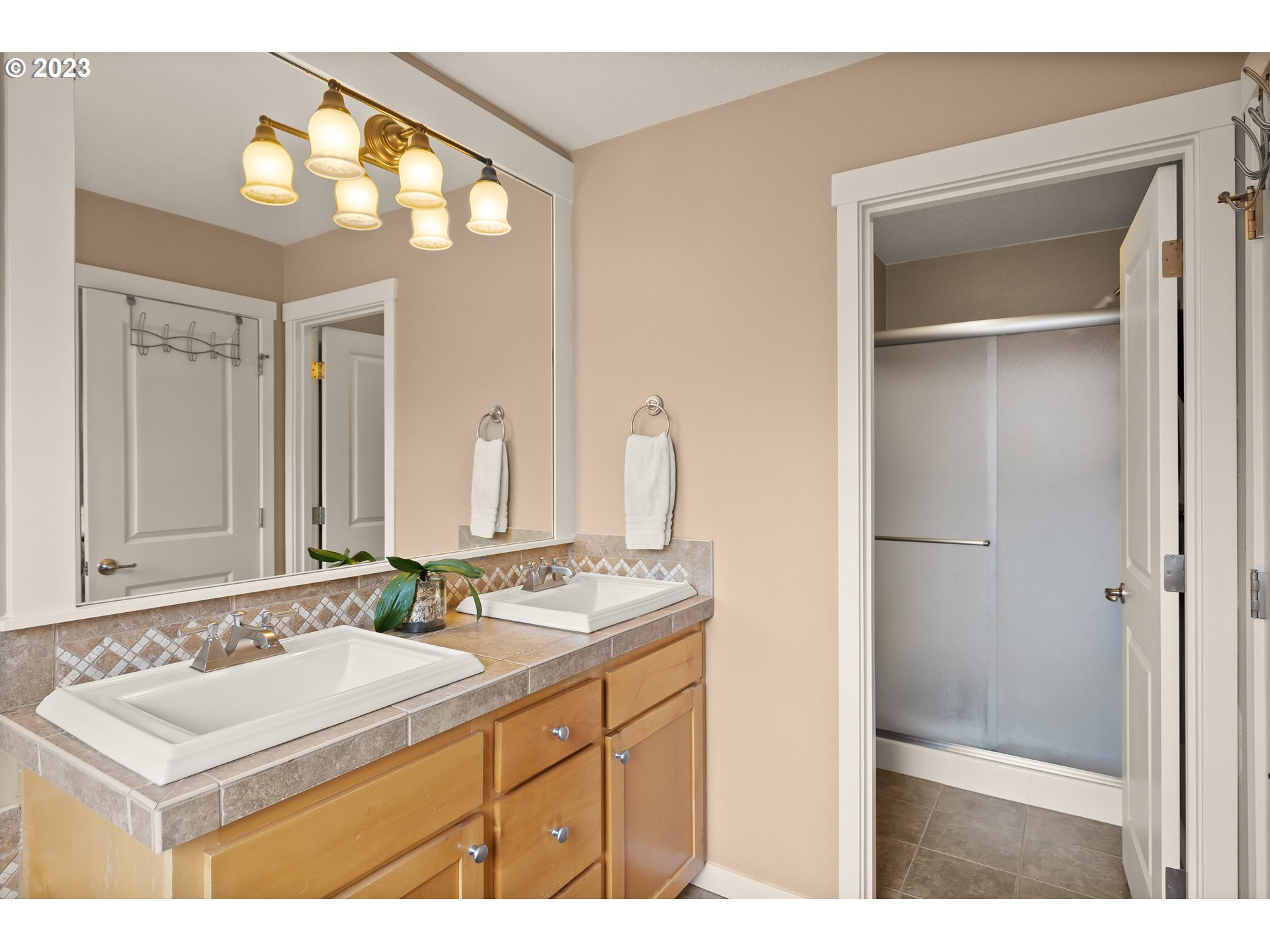 8964 Southwest Taylors Ferry Road Portland, OR 97223 - Photo 22 of 32 a bathroom with a sink vanity granite and a mirror