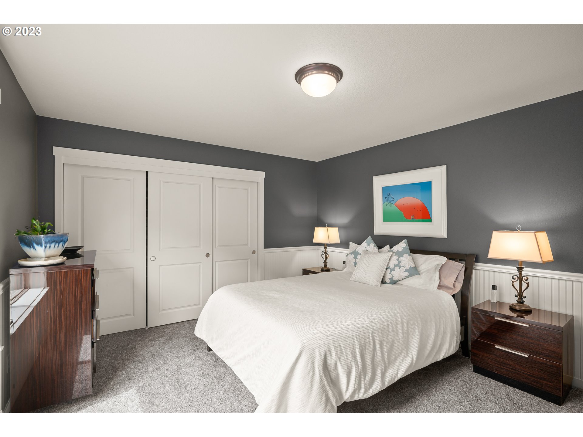 8964 Southwest Taylors Ferry Road Portland, OR 97223 - Photo 23 of 32 a bedroom with a bed and a lamp