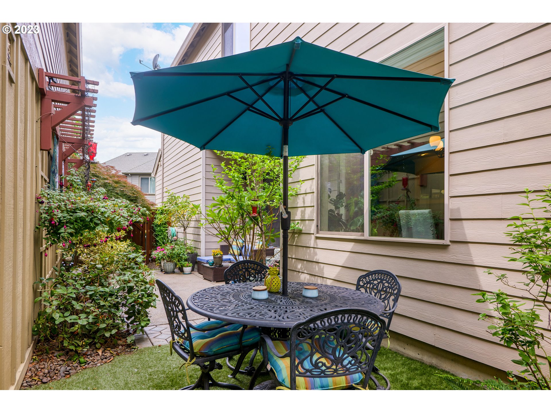 8964 Southwest Taylors Ferry Road Portland, OR 97223 - Photo 30 of 32 a view of a table and chairs under an umbrella