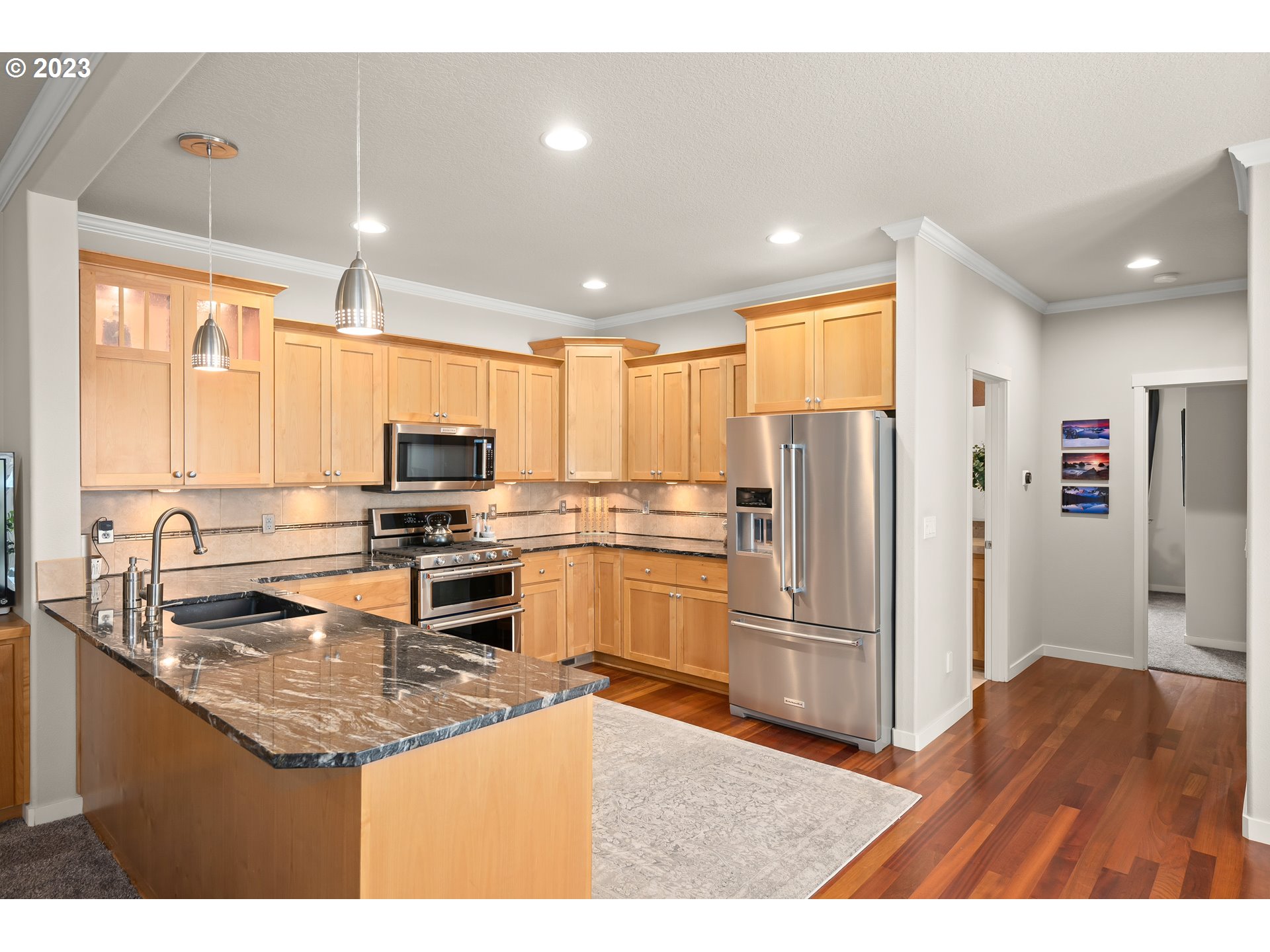 8964 Southwest Taylors Ferry Road Portland, OR 97223 - Photo 6 of 32 a kitchen with stainless steel appliances granite countertop a refrigerator a stove a sink and a microwave