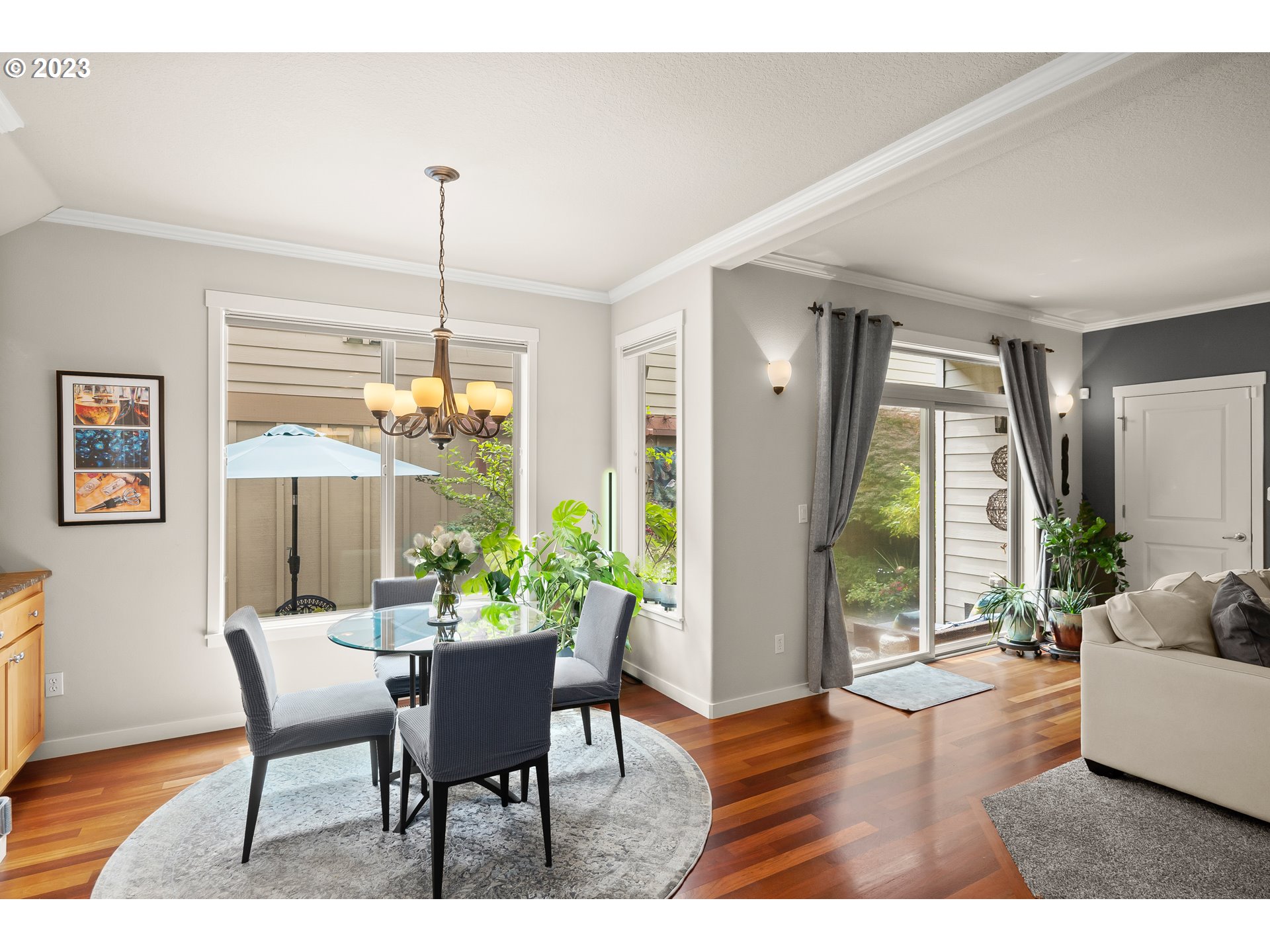 8964 Southwest Taylors Ferry Road Portland, OR 97223 - Photo 8 of 32 a dining room with furniture a chandelier and wooden floor