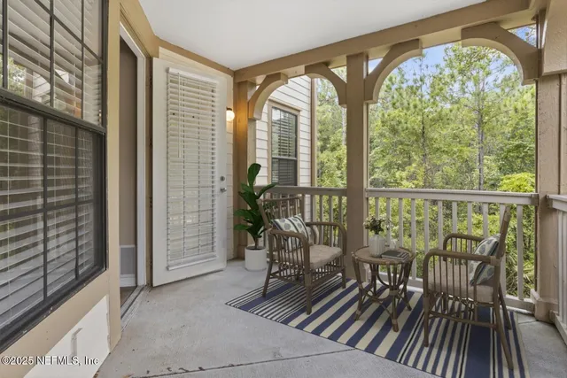 a view of a room with wooden floor and furniture