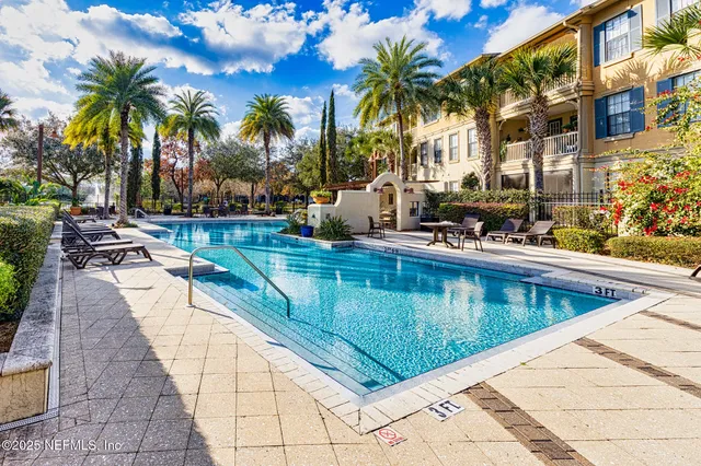 a view of swimming pool with a table and chairs