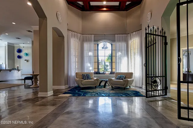 a living room with furniture and large windows