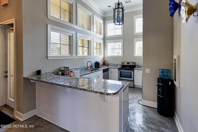 a kitchen with sink cabinets and window
