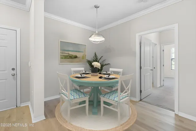 a view of a dining room with a table and chairs