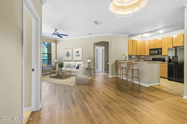 a living room with furniture and a kitchen view