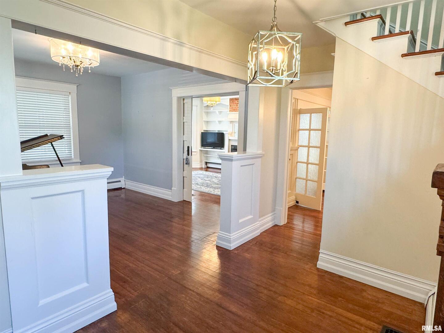 102 Southeast Front Street Dongola, IL 62926 - Photo 14 of 78 a view of a livingroom with wooden floor windows and a kitchen space