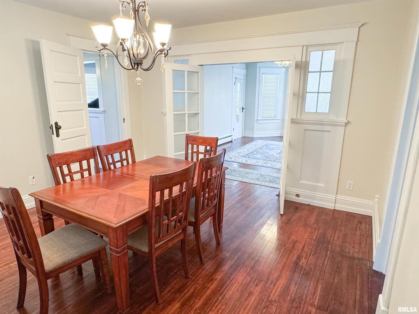 102 Southeast Front Street Dongola, IL 62926 - Photo 24 of 83 a view of a dining room with furniture wooden floor and chandelier