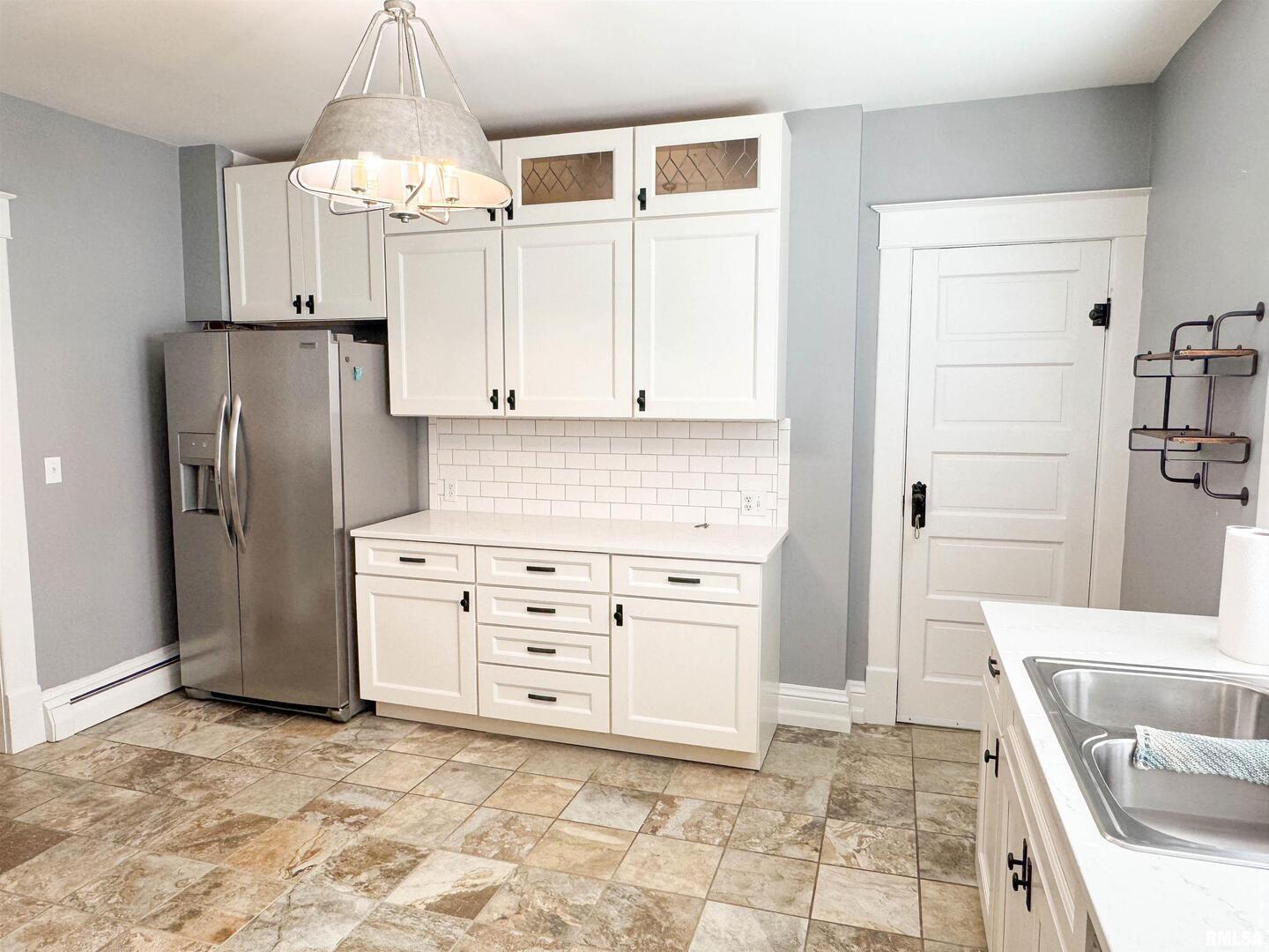 102 Southeast Front Street Dongola, IL 62926 - Photo 26 of 78 a kitchen with granite countertop a refrigerator and a stove top oven