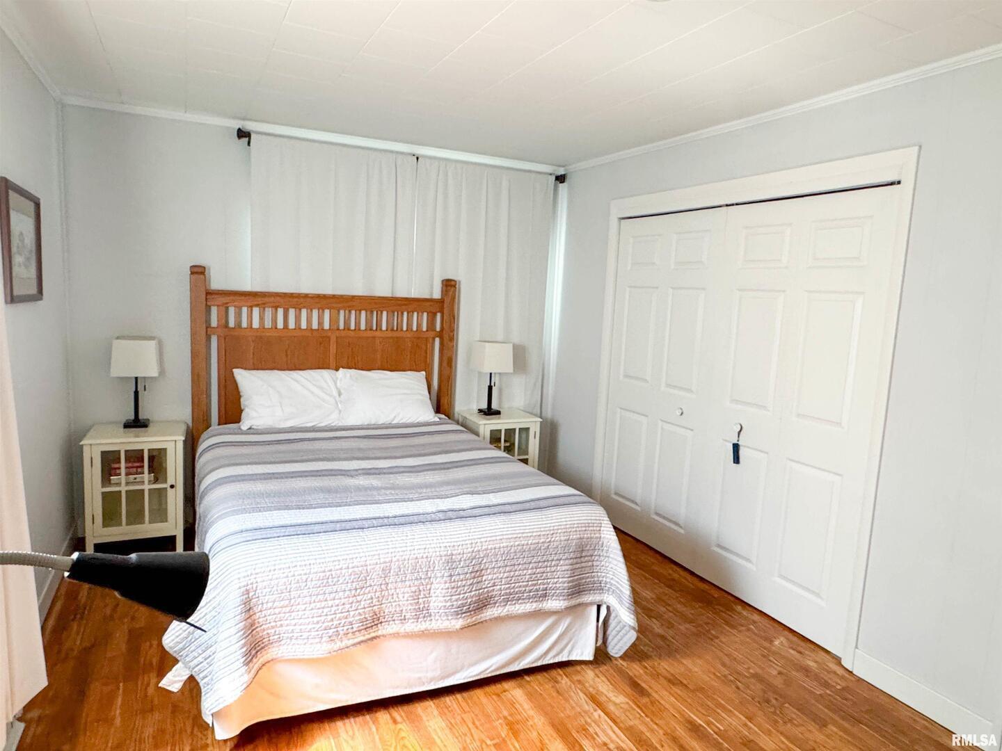 102 Southeast Front Street Dongola, IL 62926 - Photo 62 of 78 a bedroom with a bed and wooden floor