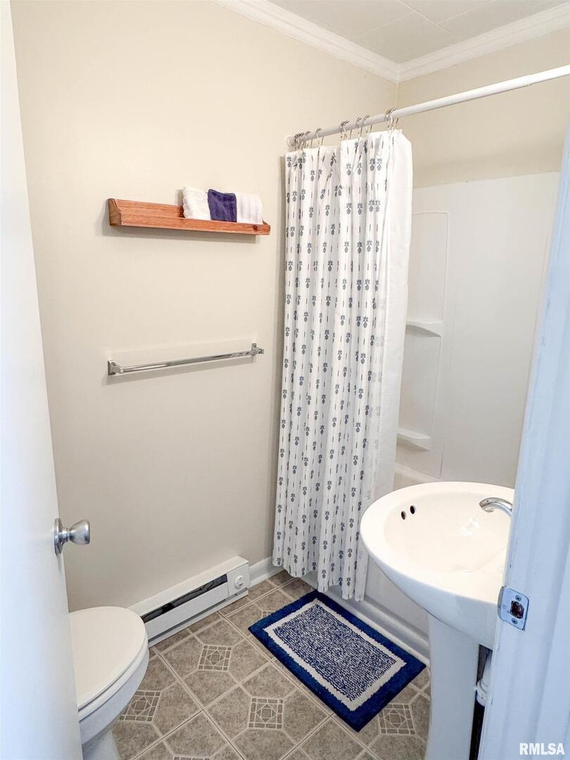 102 Southeast Front Street Dongola, IL 62926 - Photo 67 of 78 a bathroom with a toilet and a shower curtain