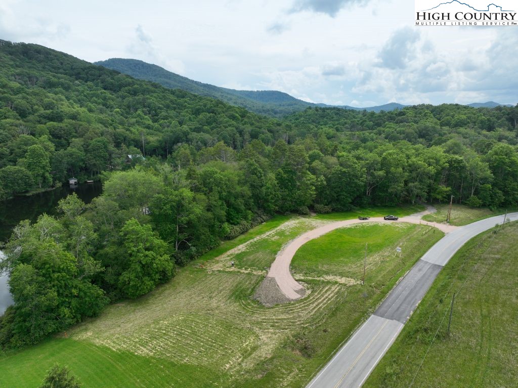 1776 Ripshin Mountain Road Roan Mountain, TN 37687 - Photo 21 of 30 a view of a lush green hillside and a houses