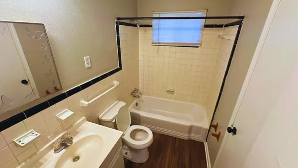 a bathroom with a tub a sink and a shower