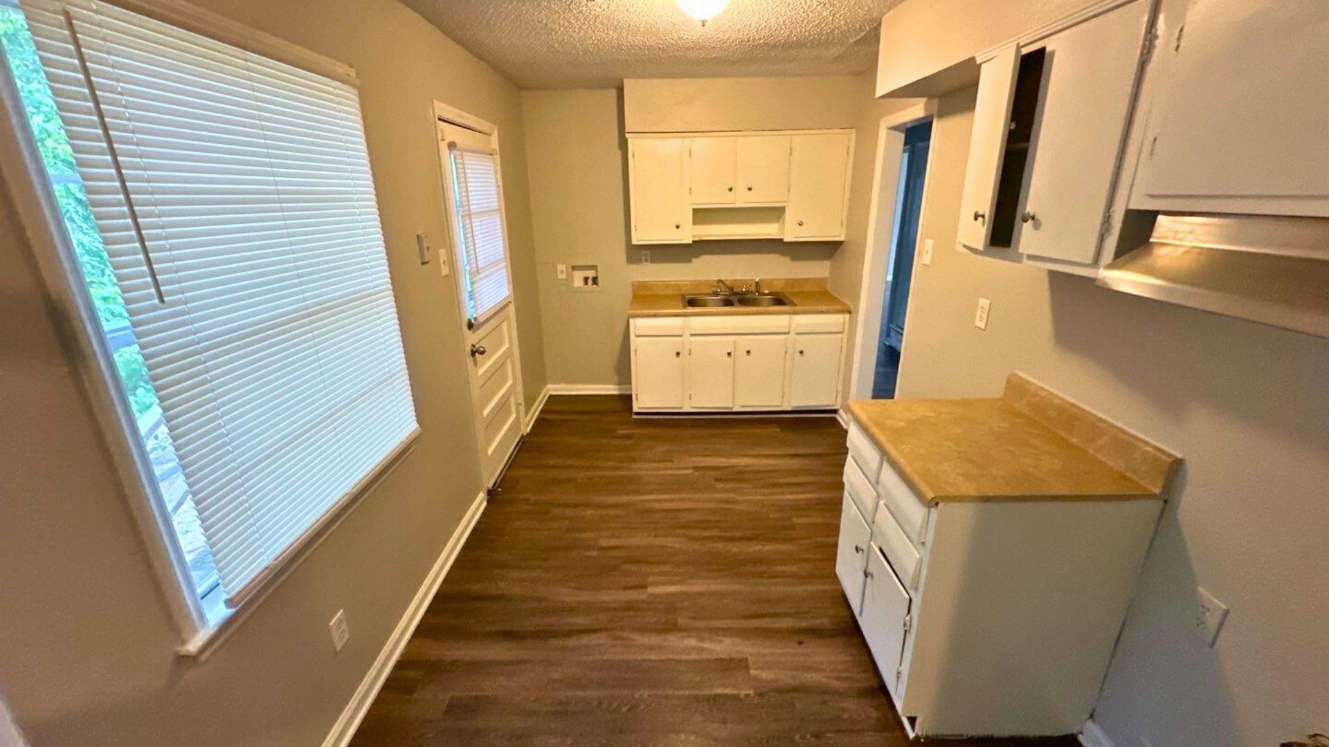3969 Ridgedale Street Memphis, TN 38127 - Photo 3 of 11 a view of a kitchen with wooden floor and electronic appliances