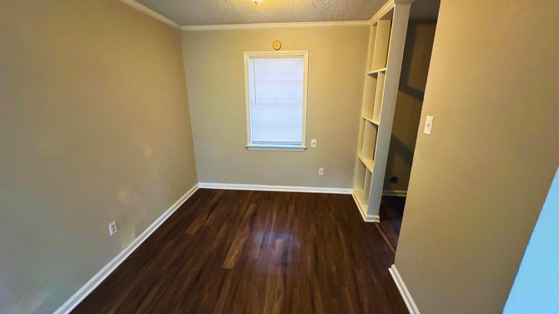 3969 Ridgedale Street Memphis, TN 38127 - Photo 6 of 11 a view of a small space with wooden floor and a window