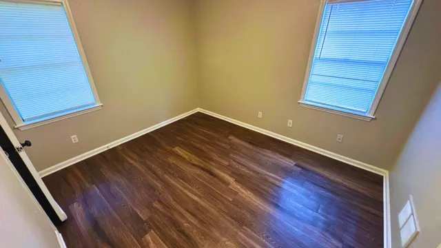 a room with wooden floor and entryway