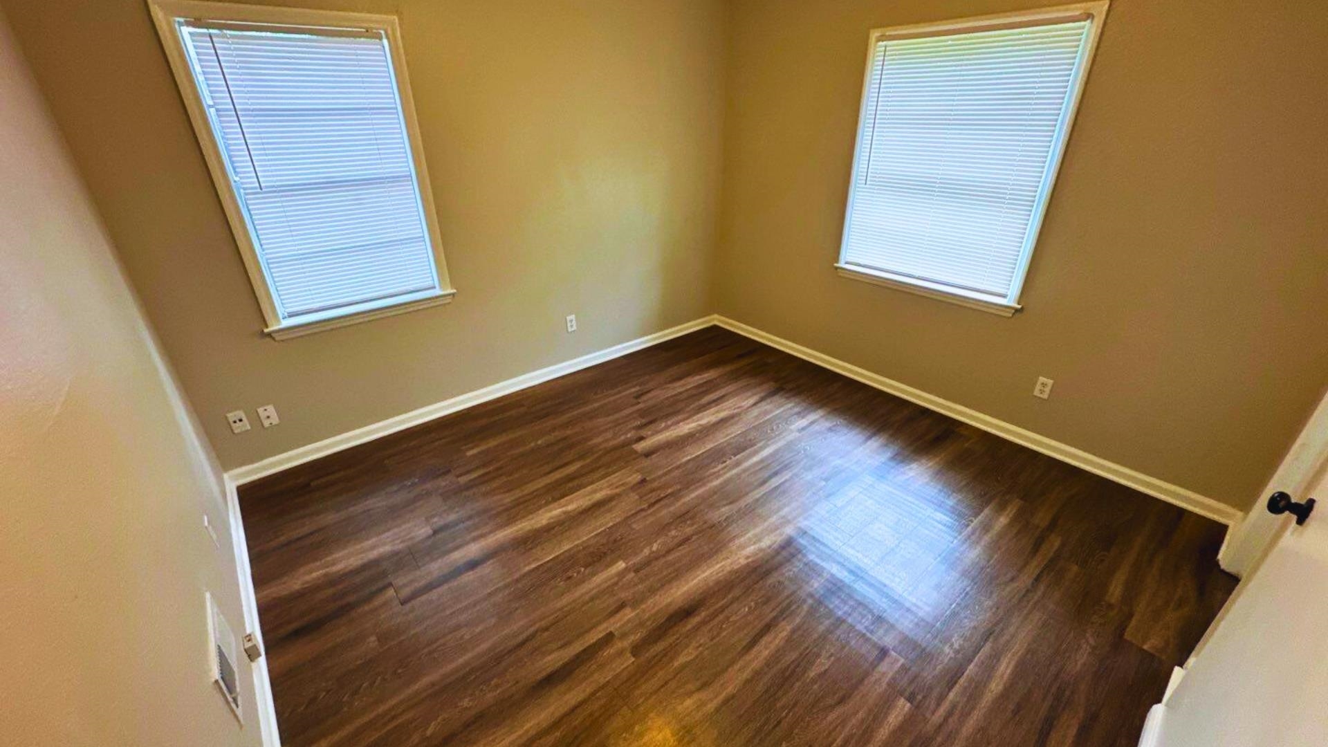 3969 Ridgedale Street Memphis, TN 38127 - Photo 10 of 11 a view of an empty room with wooden floor and a window