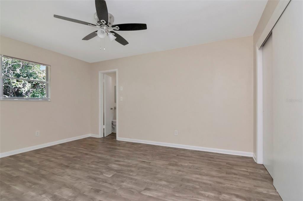 126 Kingsway Road Brandon, FL 33510 - Photo 30 of 42 an empty room with a ceiling fan and window