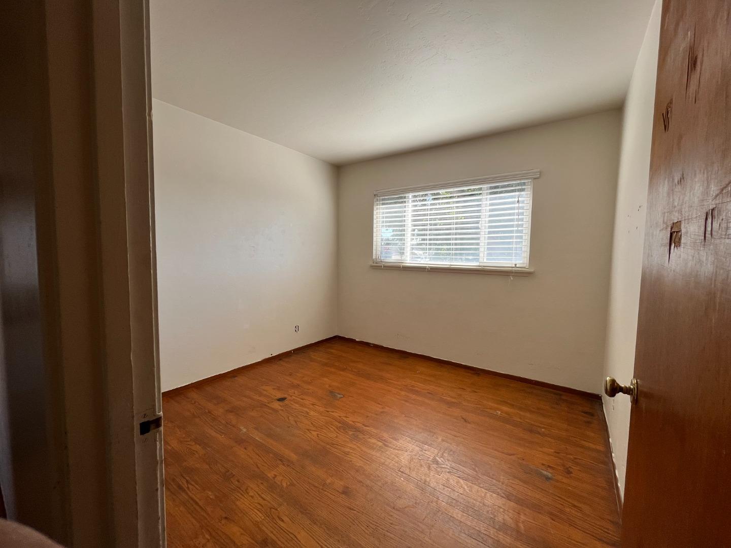 414 Crescent Way Salinas, CA 93906 - Photo 13 of 21 an empty room with wooden floor and windows