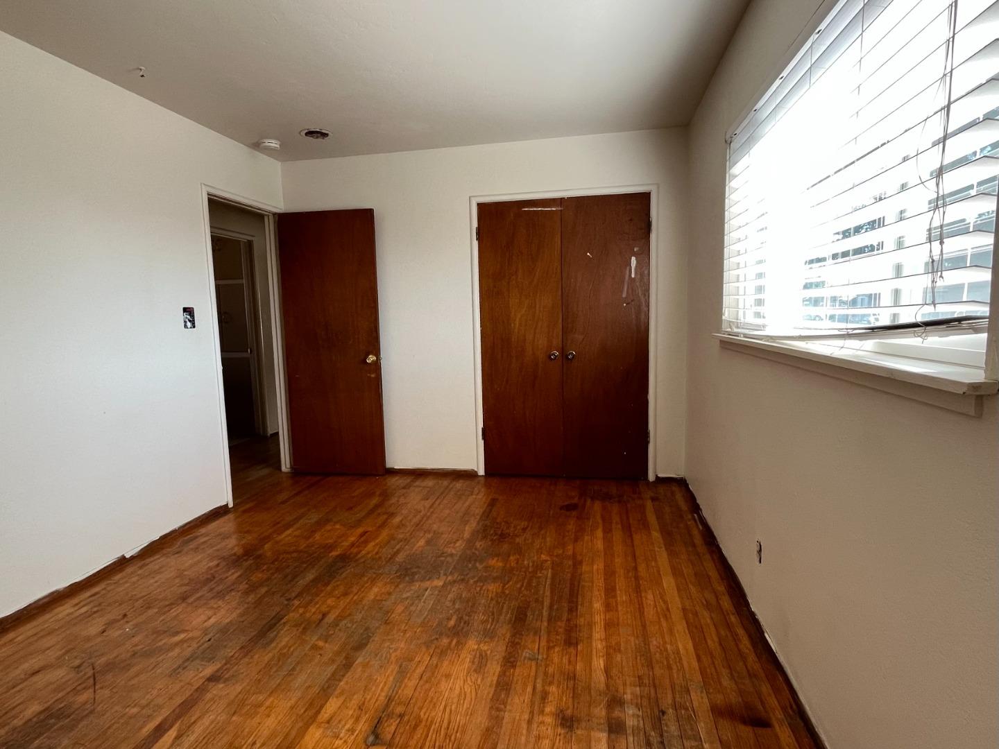 414 Crescent Way Salinas, CA 93906 - Photo 15 of 21 an empty room with wooden floor and windows