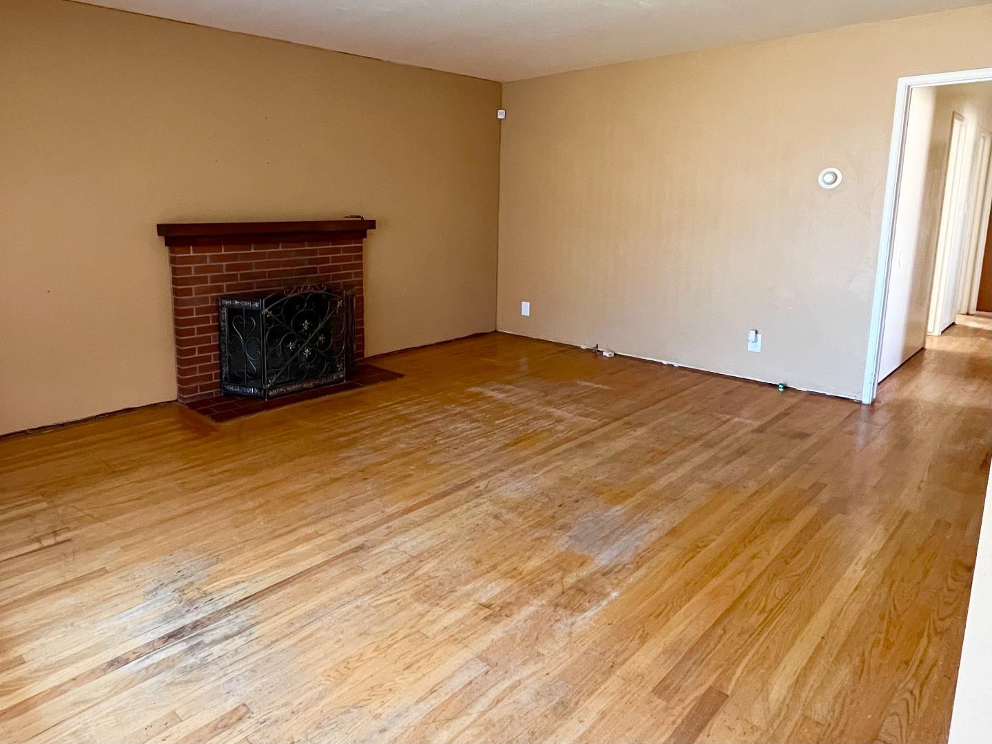 414 Crescent Way Salinas, CA 93906 - Photo 3 of 21 a view of an empty room with wooden floor and a fireplace