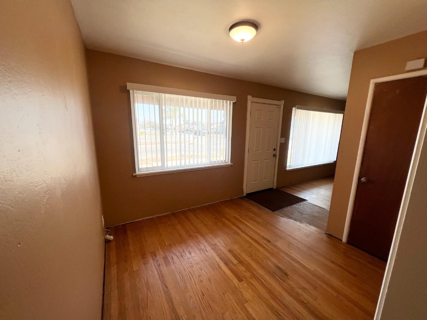 414 Crescent Way Salinas, CA 93906 - Photo 8 of 21 an empty room with wooden floor and windows