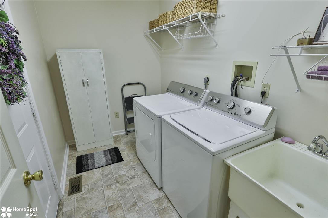507 Howertown Road Northampton, PA 18067 - Photo 3 of 46 A well-appointed laundry room features a utility sink and convenient wall shelving for storage.
