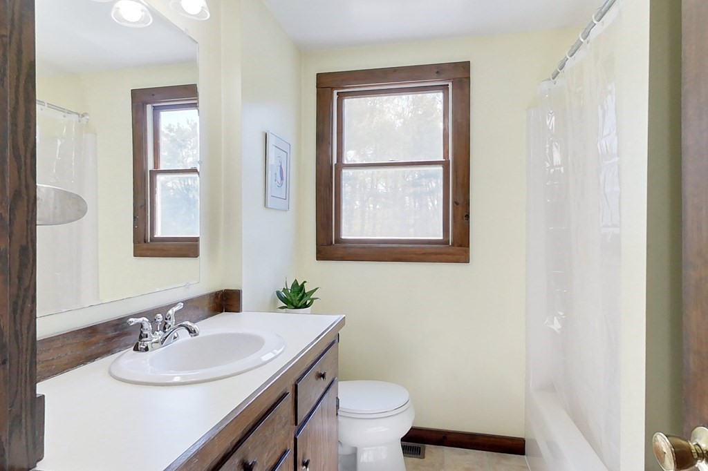 59 Pillsbury Road Ashby, MA 01431 - Photo 17 of 42 a bathroom with a granite countertop sink toilet and mirror