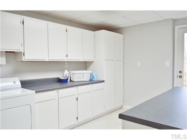 2405 Countrywood Road Raleigh, NC 27615 - Photo 16 of 25 You are going to love this laundry room! It has lots of cabinets on both sides, a soaking tub, and lots of natural light. You could also use this for crafts and hobbies. Laundry Room