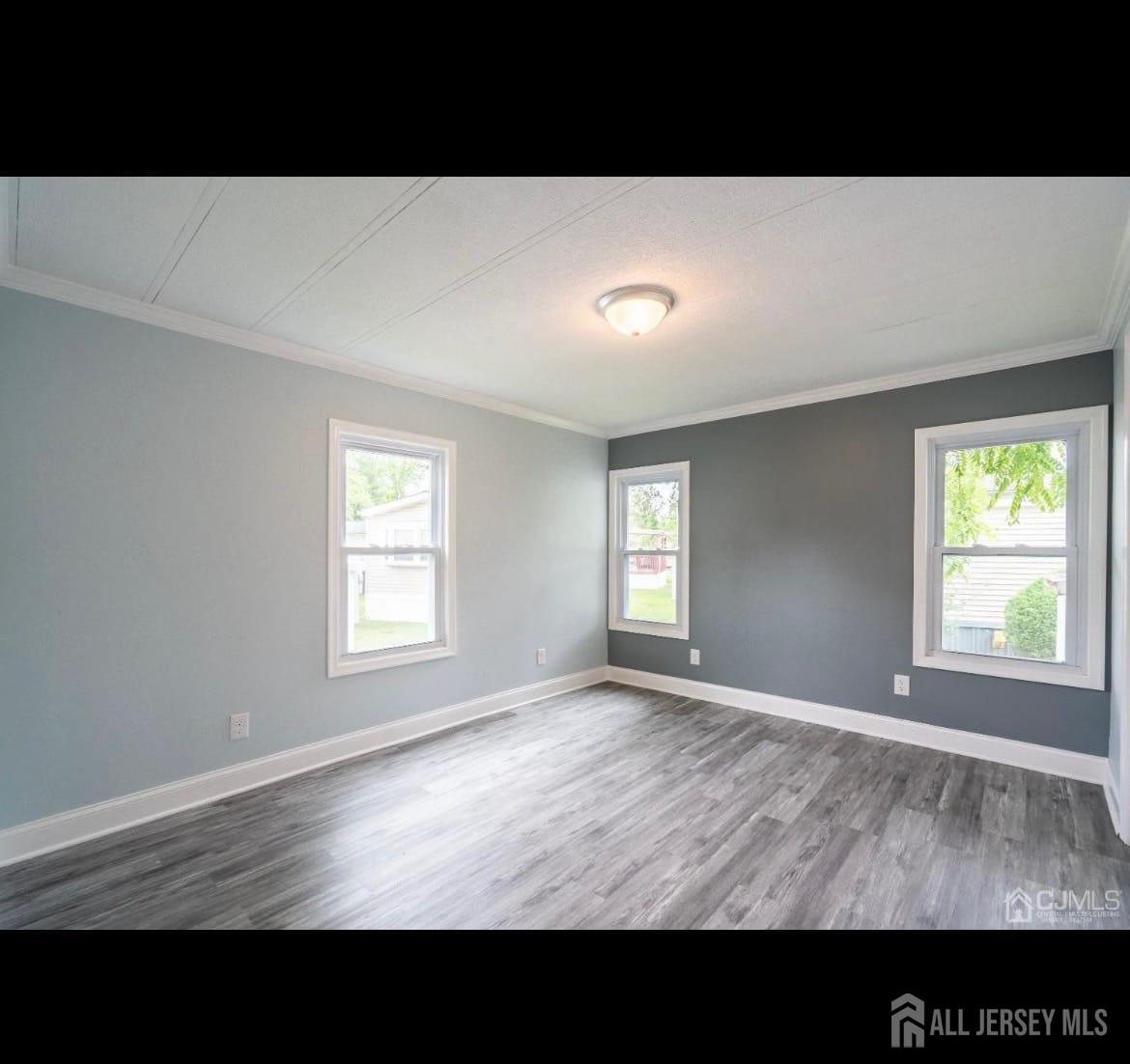 14 Byron Road North Brunswick, NJ 08902 - Photo 14 of 27 a view of an empty room with wooden floor and a window