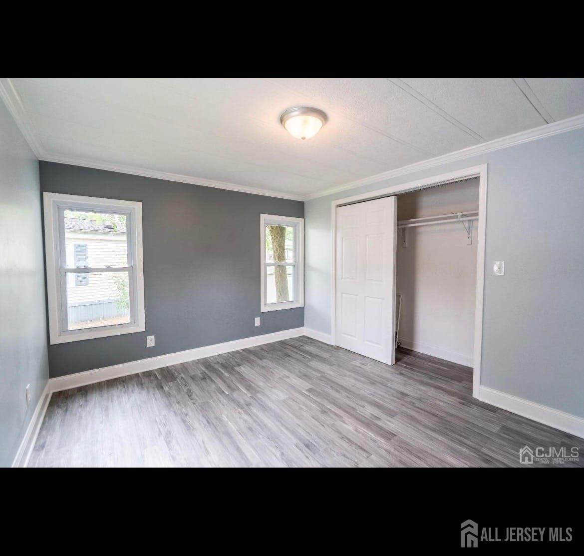 14 Byron Road North Brunswick, NJ 08902 - Photo 15 of 27 a view of an empty room with window and wooden floor