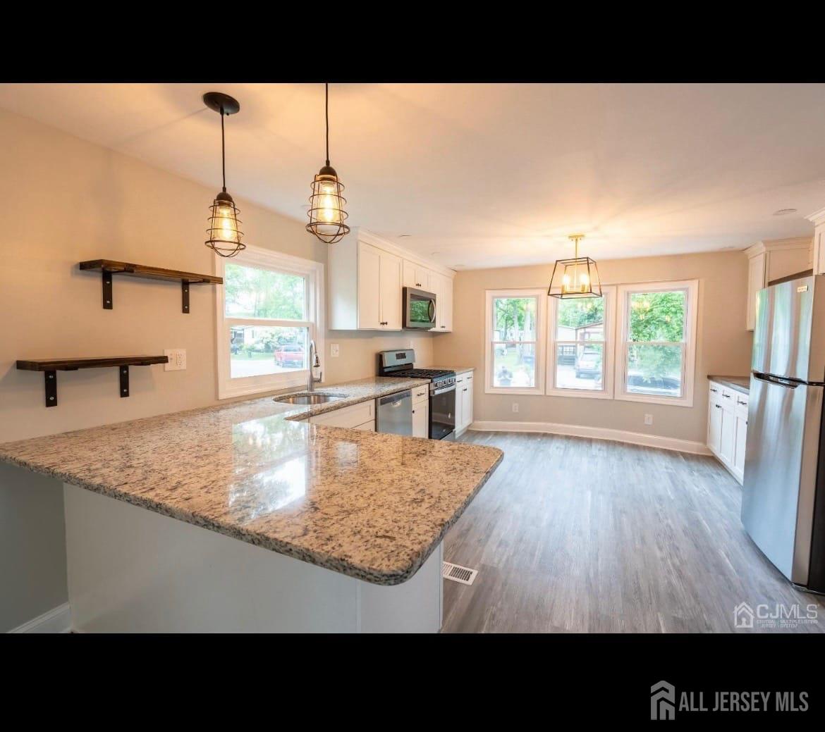 14 Byron Road North Brunswick, NJ 08902 - Photo 5 of 27 a open kitchen with cabinets and wooden floor