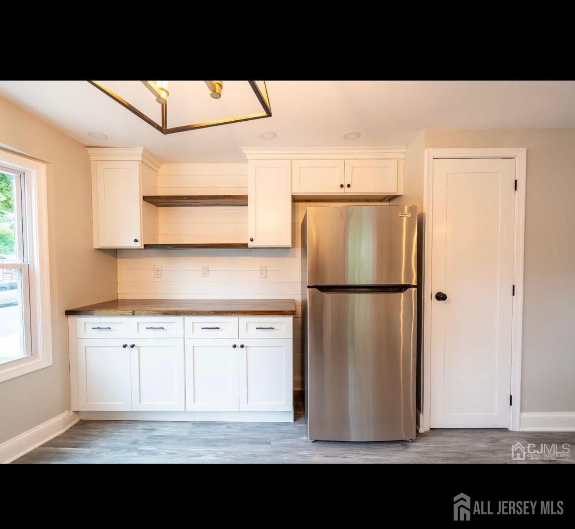 14 Byron Road North Brunswick, NJ 08902 - Photo 7 of 27 a view of kitchen with stainless steel appliances kitchen island a refrigerator sink and cabinets