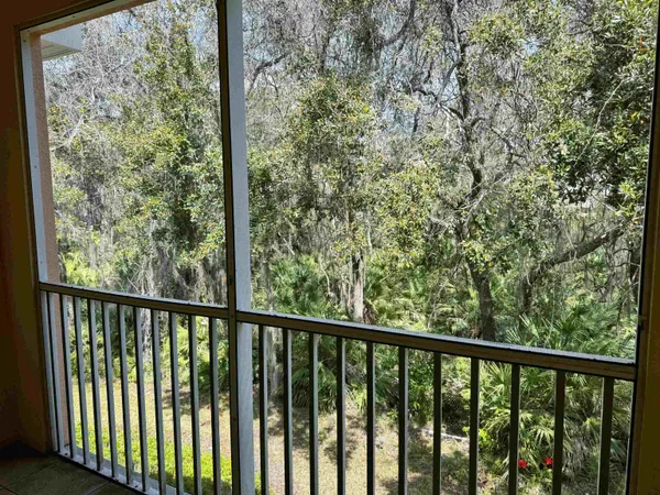 an empty room with a window and a ceiling fan