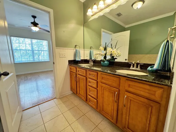 a bathroom with a glass shower door and mirror