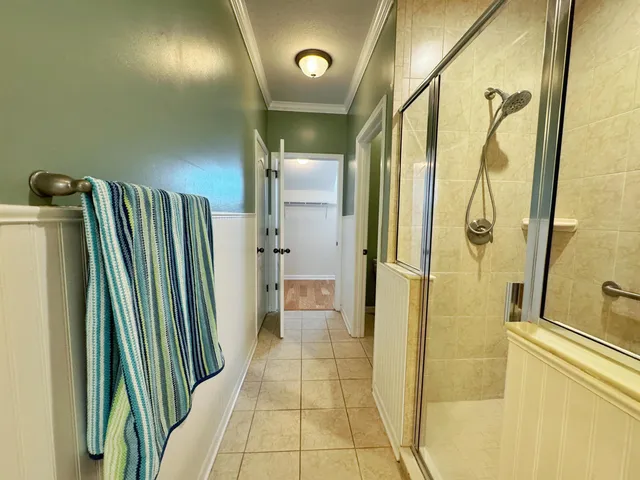a view of a room with wooden floor and small window