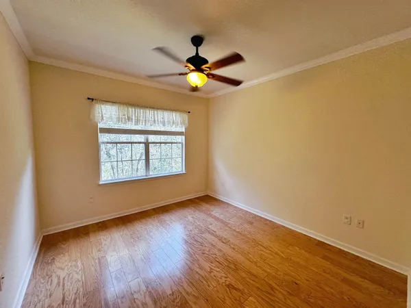 a spacious bathroom with a granite countertop sink a toilet and a mirror