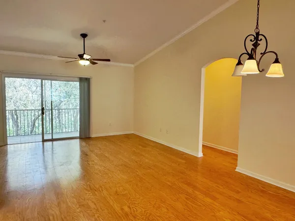 a view of a kitchen with wooden floor and a ceiling fan
