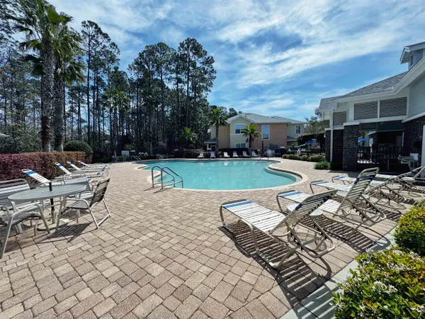 a view of a swimming pool with lounge chairs