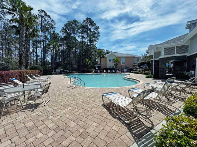 a view of a swimming pool with lounge chairs