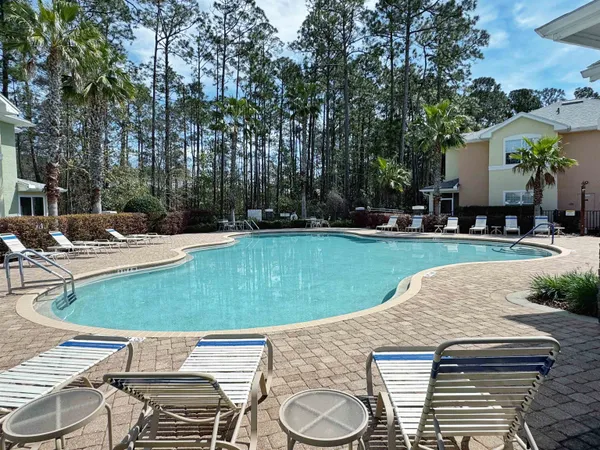 a living room with furniture and large windows