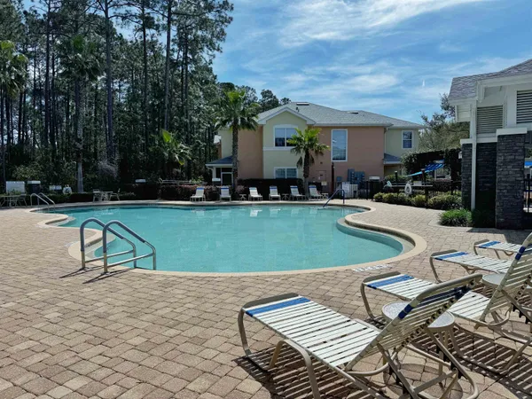 a view of a patio with table and chairs potted plants