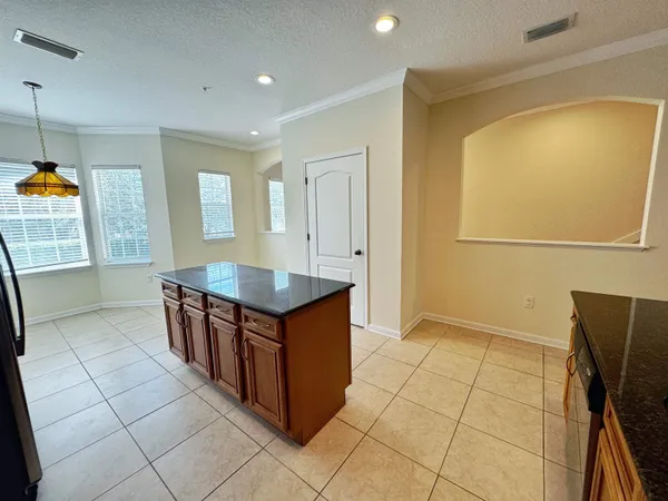 a kitchen with stainless steel appliances granite countertop a sink a counter top space cabinets and a counter top space