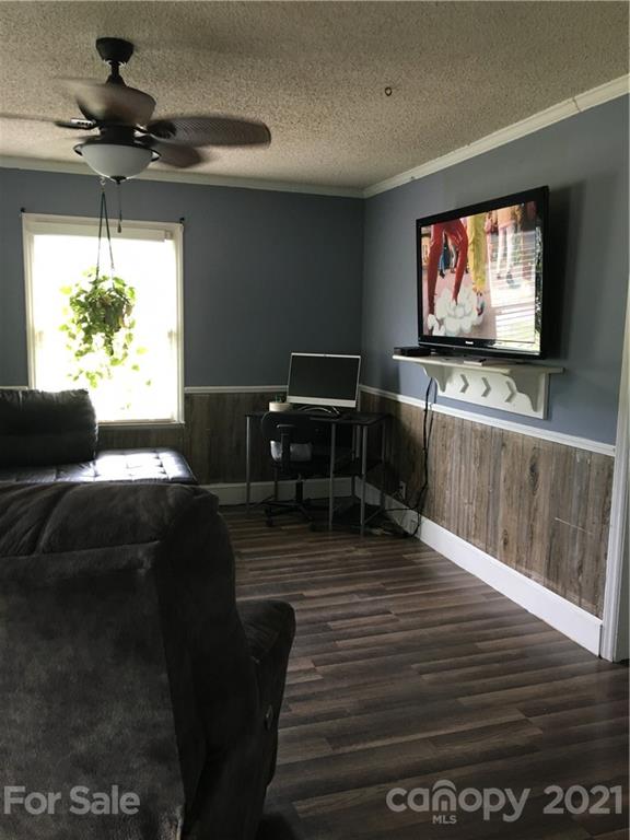 203 North Love Chapel Road Stanfield, NC 28163 - Photo 14 of 19 a living room with furniture and a flat screen tv