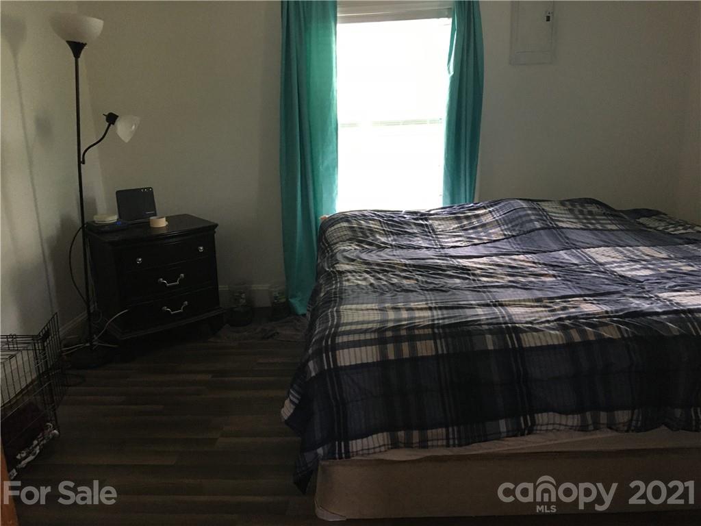 203 North Love Chapel Road Stanfield, NC 28163 - Photo 15 of 19 a living room with a stove and a window