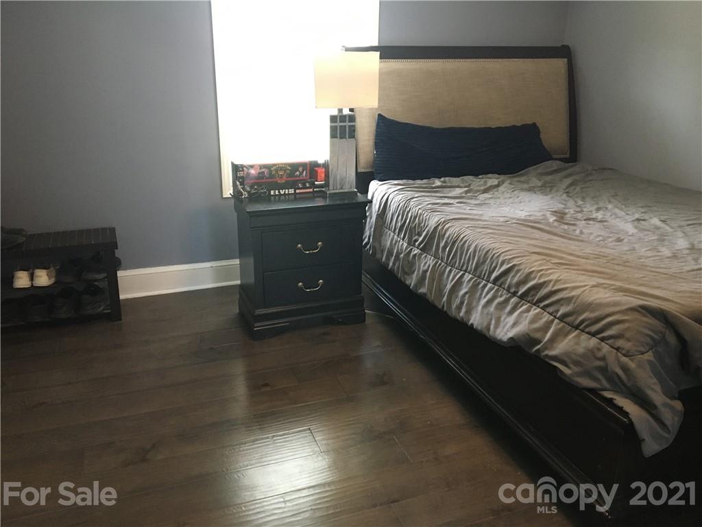 203 North Love Chapel Road Stanfield, NC 28163 - Photo 17 of 19 a bed sitting in a bedroom next to a window